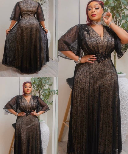 Woman wearing a black lace dress with sheer sleeves, posing in front of a mirror.